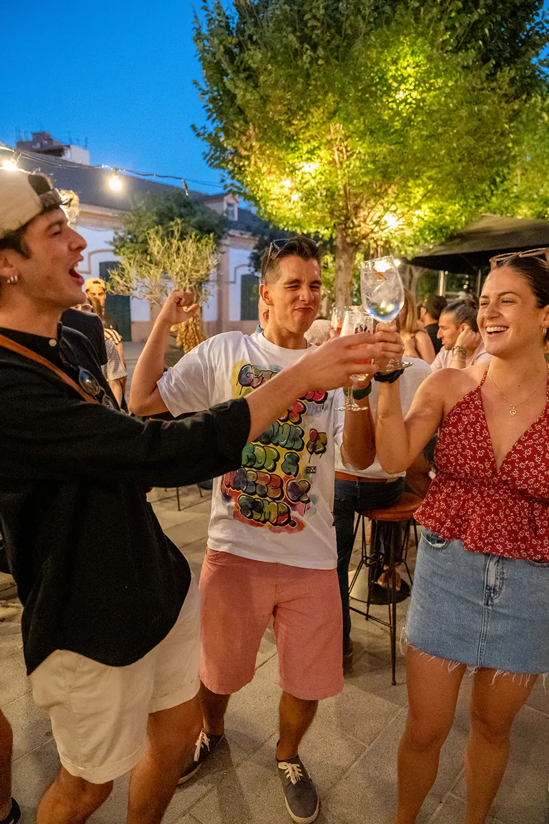 Friends raising a glass at night on Andana's terrace