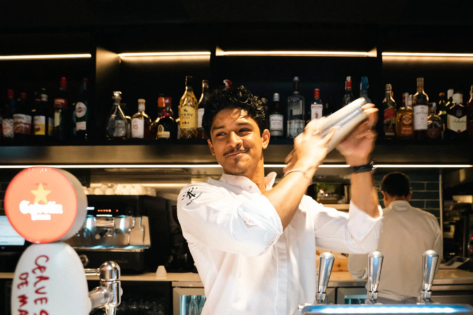 A bartender mixing a cocktail at Andana's bar