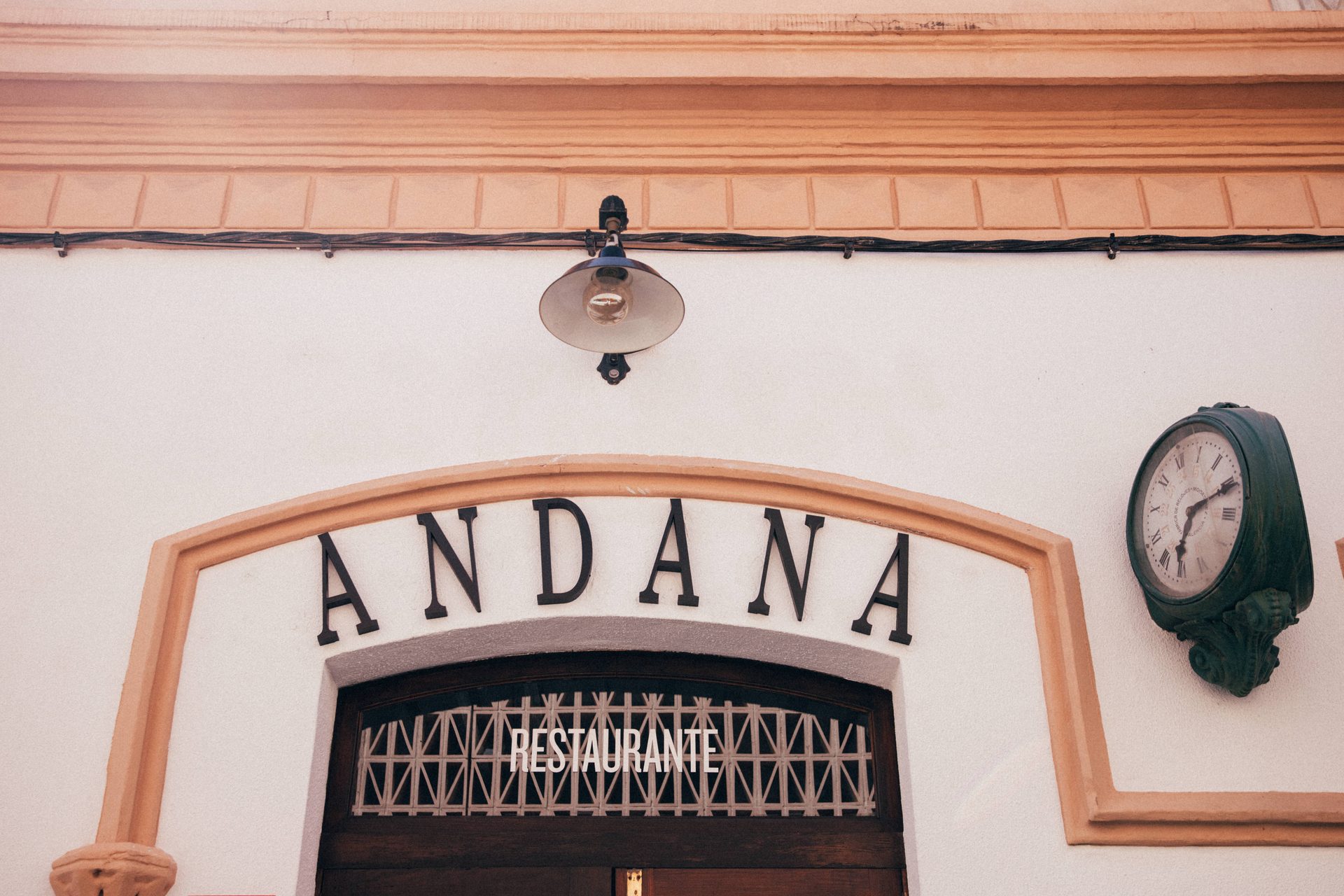 Andana's façade with its sign and the old station clock