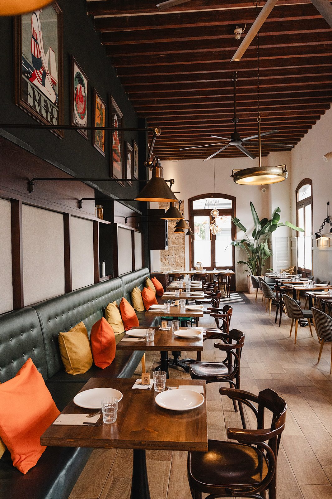 Andana's dining room, with its green banquettes and orange cushions